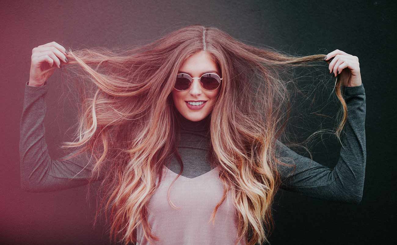 beautiful women showing her hair style and smilling with sunglasses