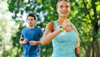 couple doing morning exercise in park under the tree