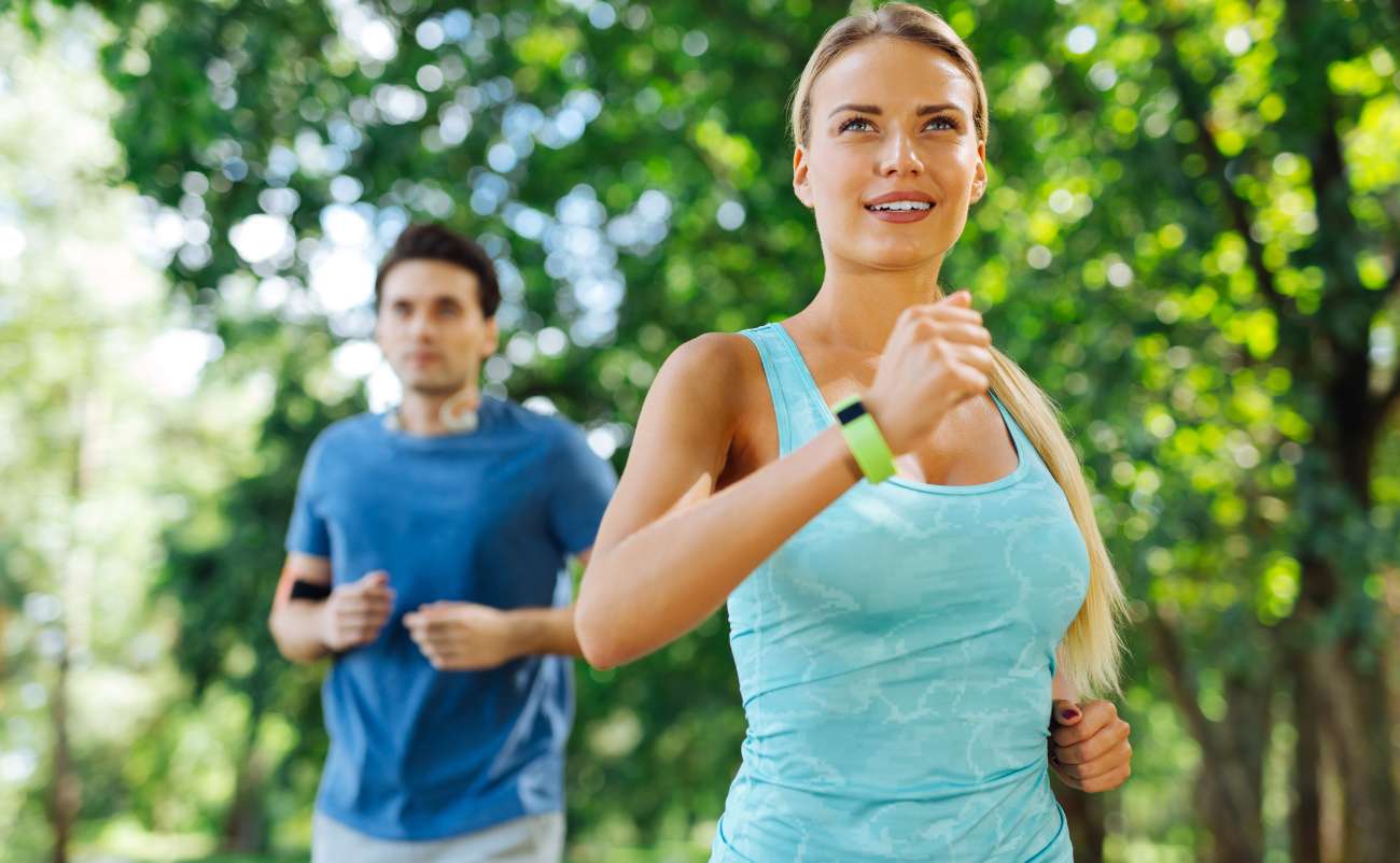 couple doing morning exercise in park under the tree