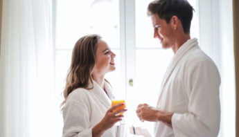 couple enjoying juice at home in night dress