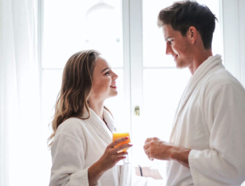 couple enjoying juice at home in night dress