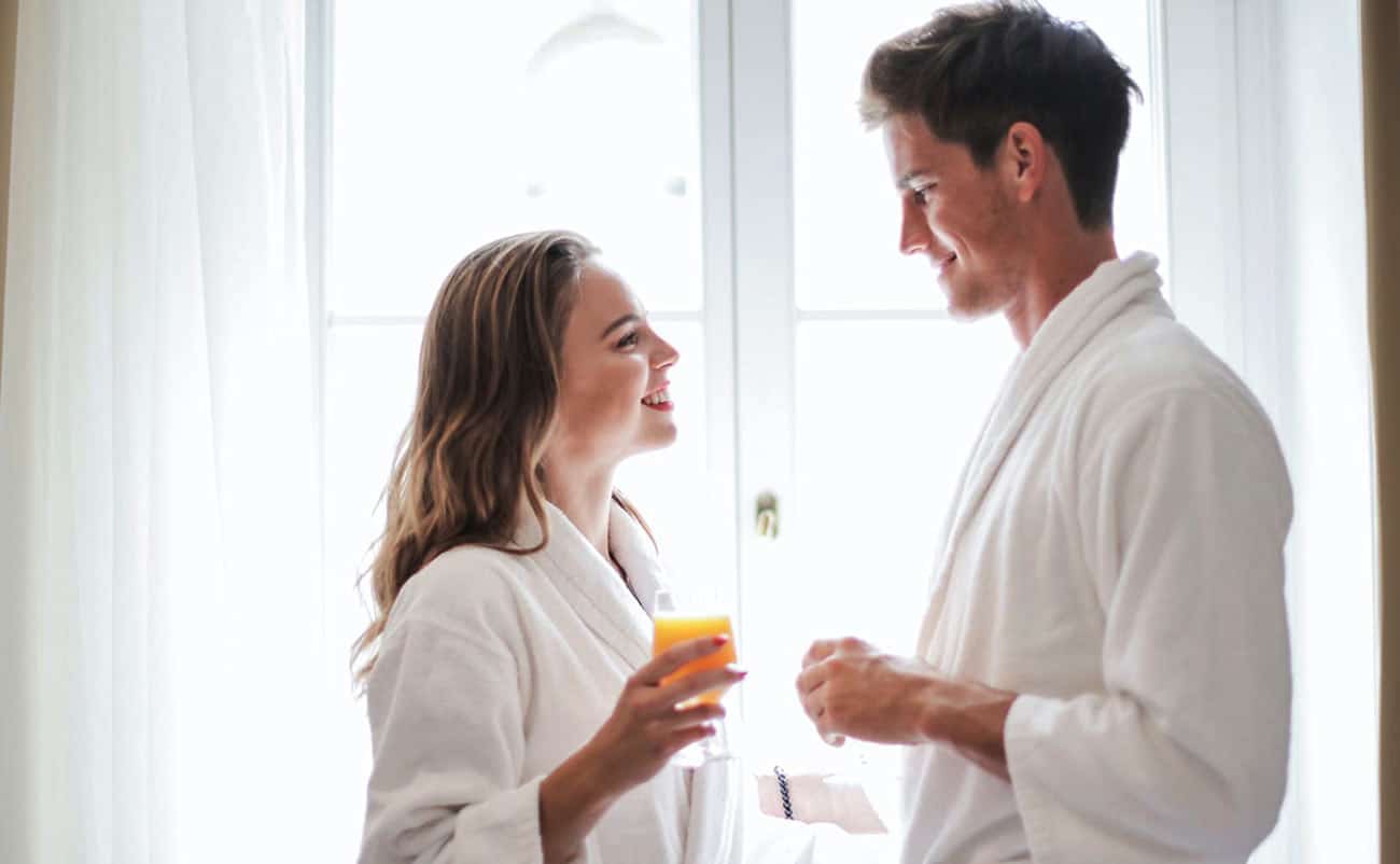 couple enjoying juice at home in night dress