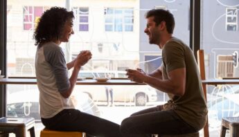 couple talking over coffee to keep relationship positive