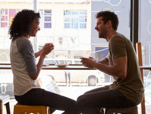 couple talking over coffee to keep relationship positive