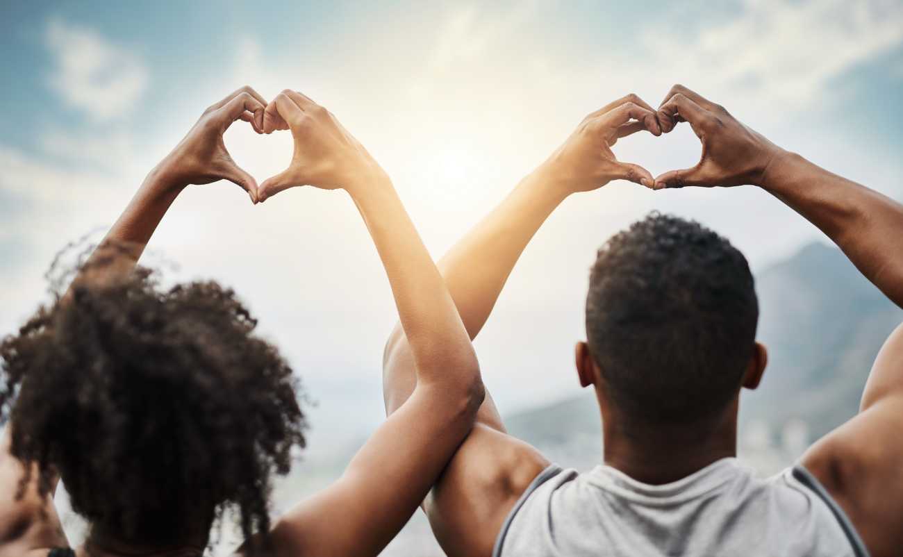 healthy couple relaxing and showing heart sign with hand