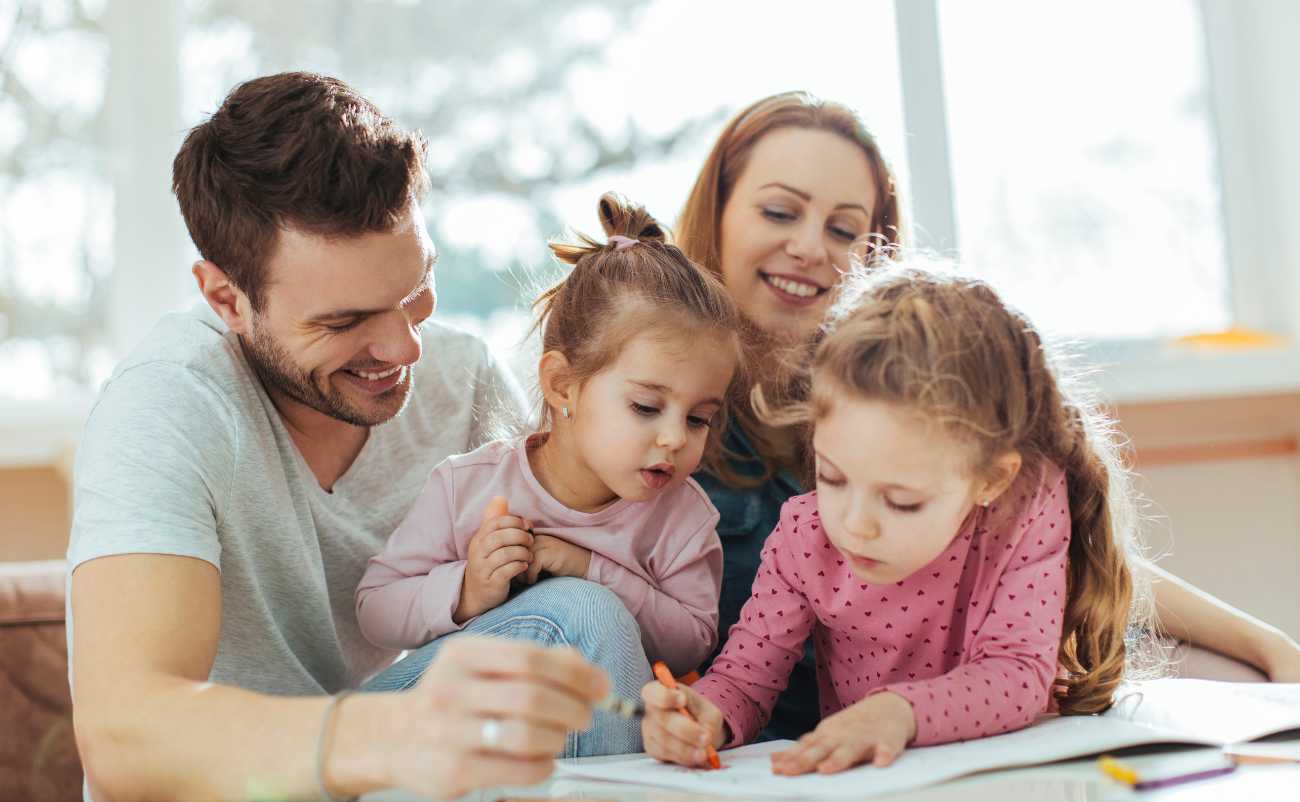 parents enjoying family time with kids helping painting