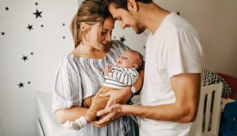 parents holding their baby with care