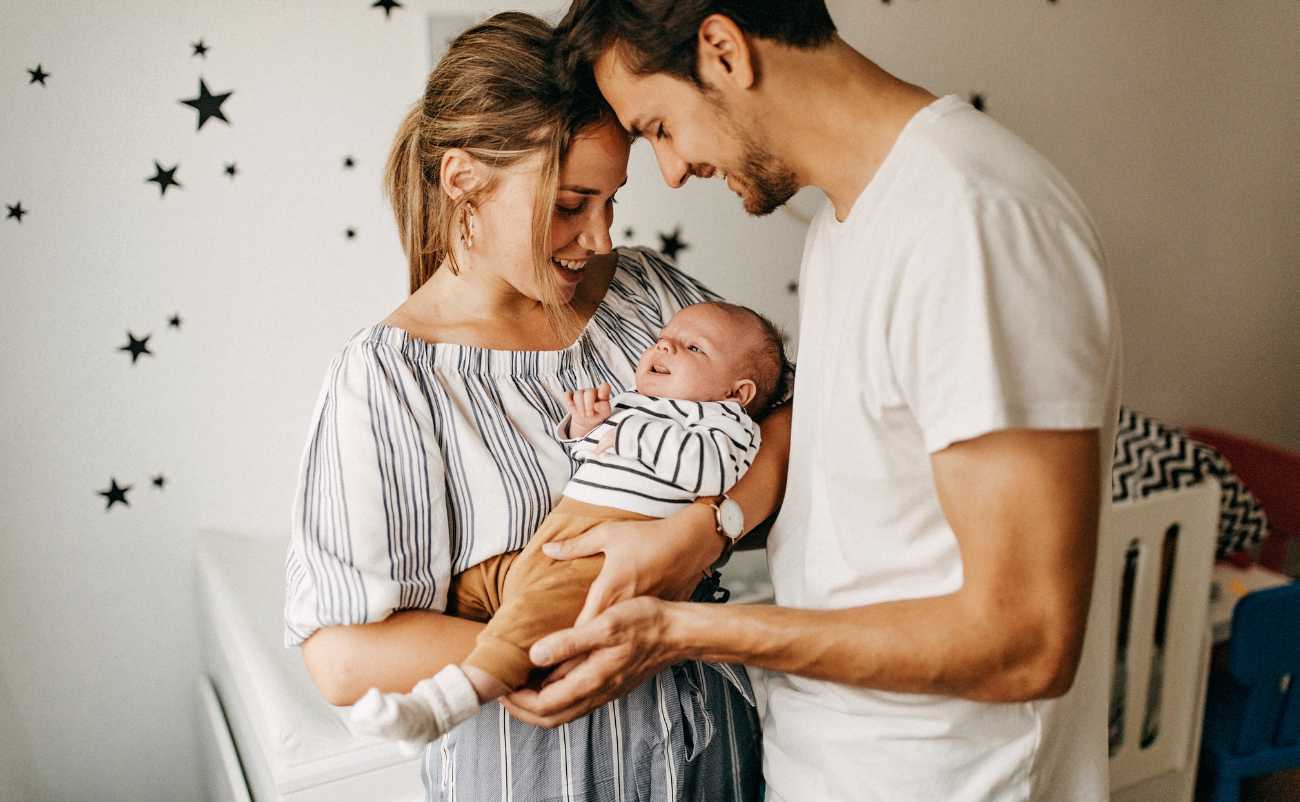 parents holding their baby with care