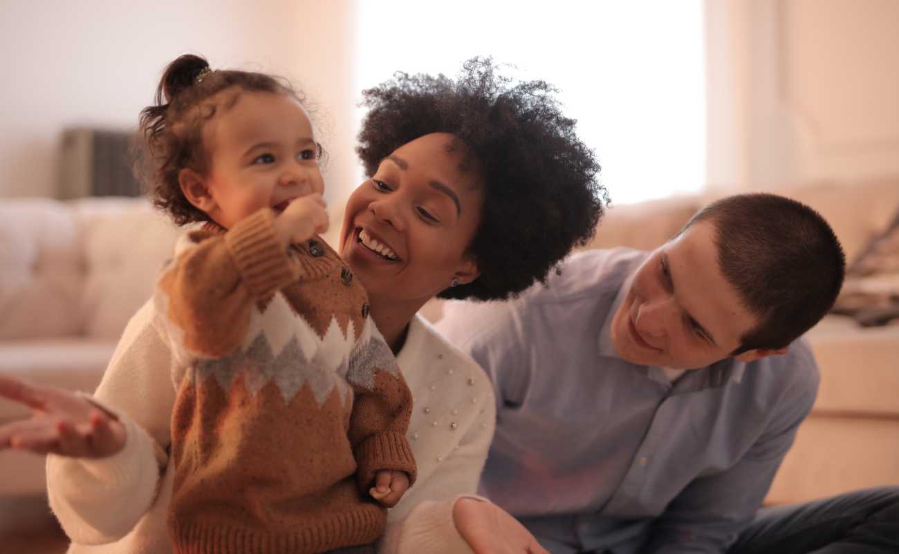 parents playing with their daughter at home