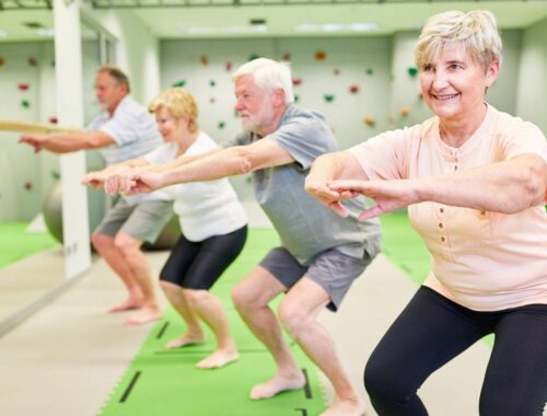 seniors group doing stretching activity at gym