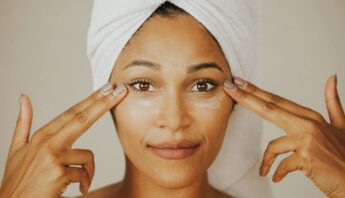 women applying sunscreen to protect skin at home