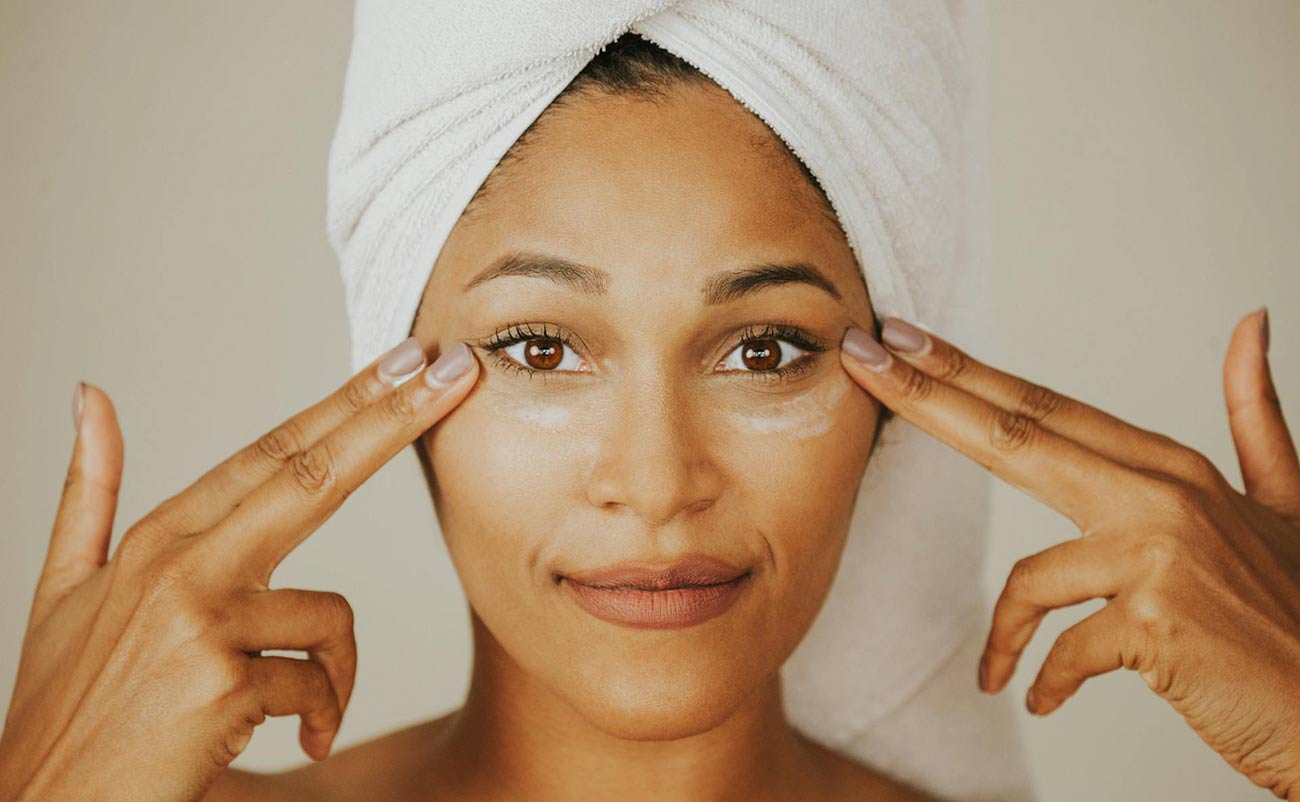 women applying sunscreen to protect skin at home