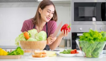 women cutting red pepper and vegetable in the kitchen