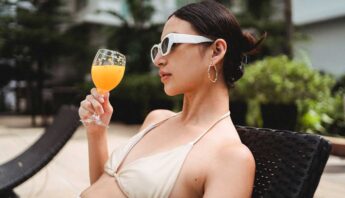 women drinking juice at swimming pool