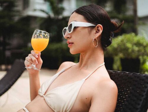 women drinking juice at swimming pool