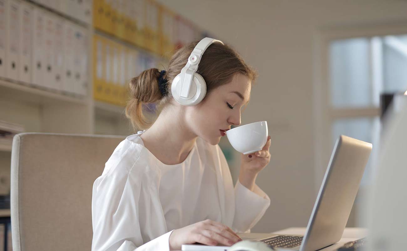 women working on laptop drinking cofee tea with headphone